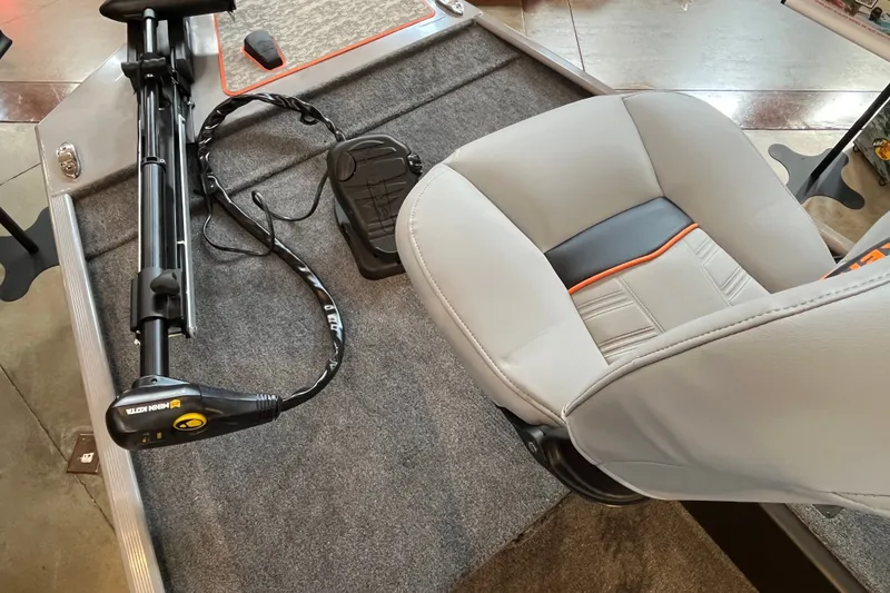 Slide: The Image of 2027 Tracker Bass Tracker Classic Limited boat interior with trolling motor and cushioned seat. - 14