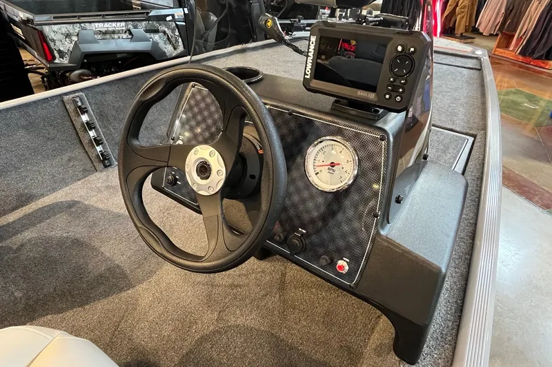 Slide: The Image of 2027 Tracker Bass Tracker Classic Limited boat dashboard with steering wheel and navigation system. - 17