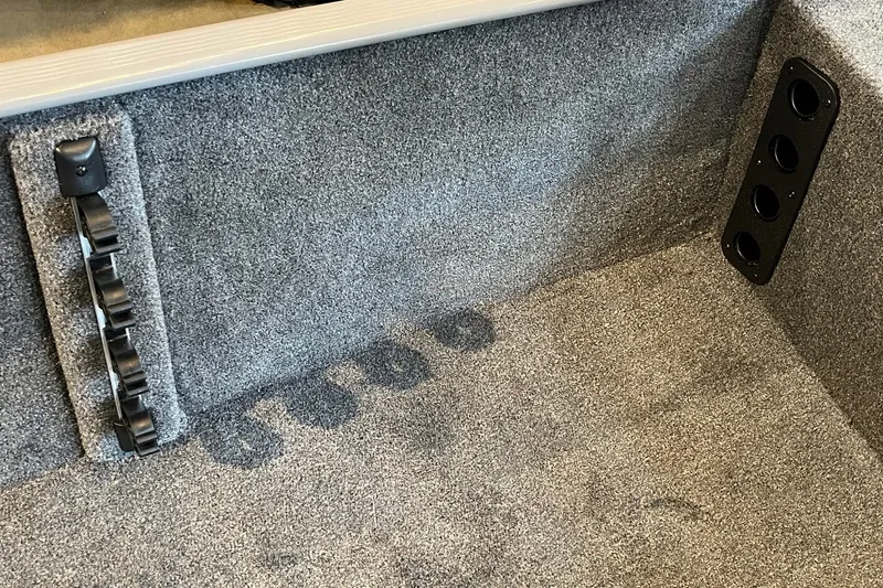 Slide: The Image of Interior of 2027 Tracker Bass Tracker Classic Limited boat with carpeted flooring and rod holders. - 20