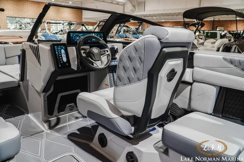 Slide: The Image of Interior of a 2027 Malibu M230 boat featuring modern dashboard and luxurious seating. - 21