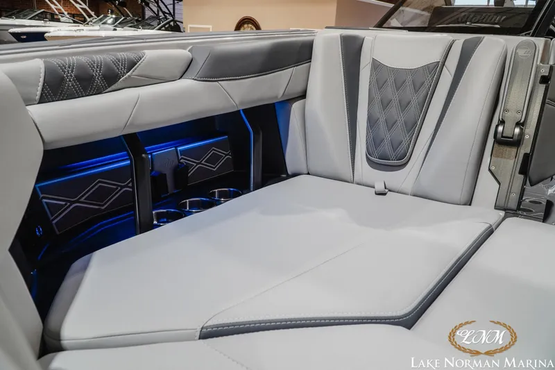 Slide: The Image of Luxurious interior of 2027 Malibu M230 boat with elegant seating and ambient lighting. - 6