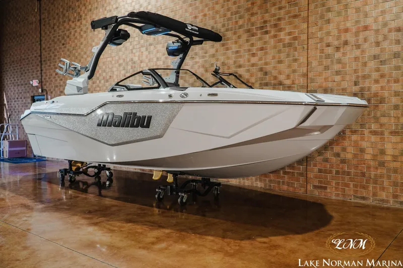 Slide: The Image of 2027 Malibu M230 boat displayed indoors at Lake Norman Marina. - 3