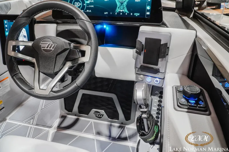 Slide: The Image of 2027 Malibu M230 boat cockpit with modern steering wheel and advanced control panel. - 23