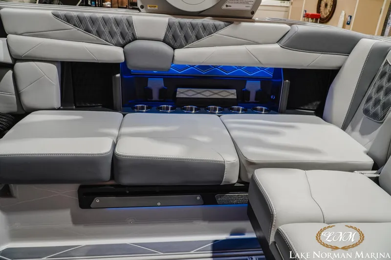 Slide: The Image of Luxurious interior seating of 2027 Malibu M230 boat with modern design and cup holders. - 19