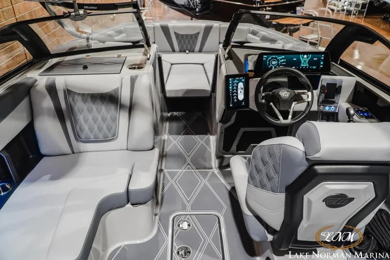Slide: The Image of Luxurious interior of 2027 Malibu M230 boat with modern dashboard and seating. - 20