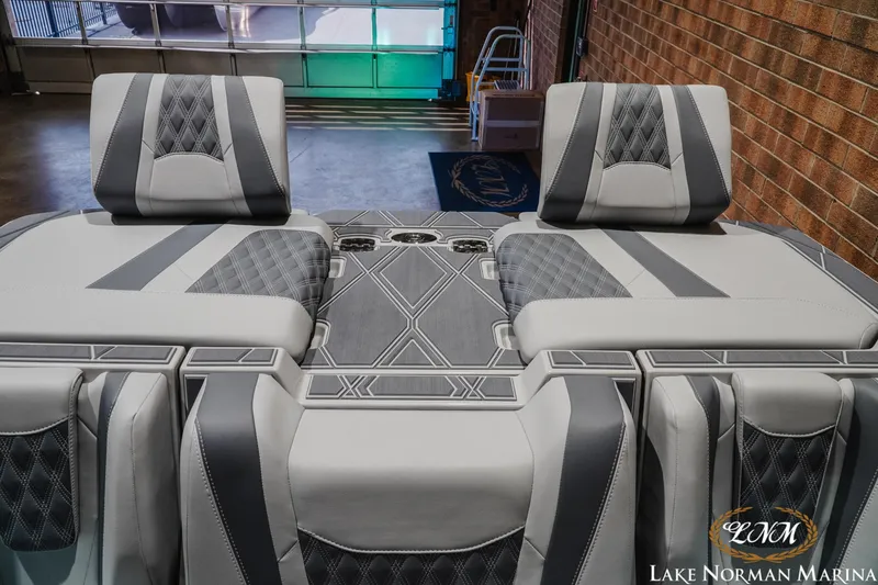 Slide: The Image of 2027 Malibu M230 boat interior with stylish gray seating and diamond-patterned upholstery. - 33