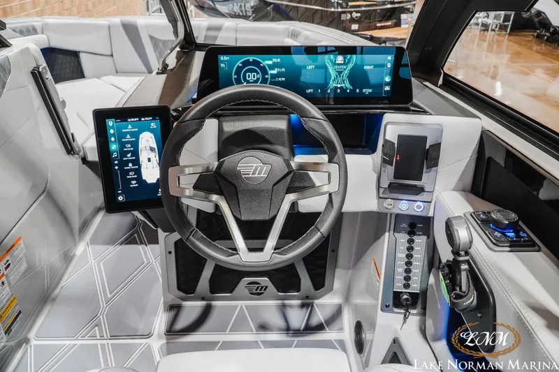 Slide: The Image of 2027 Malibu M230 boat dashboard with advanced digital controls and sleek steering wheel design. - 22