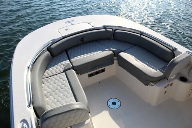 Slide: The Image of 2025 Carolina Skiff 21 Ultra Elite boat with cushioned seating, on calm water. - 9