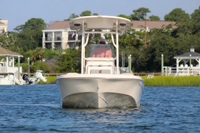 Slide: The Image of 2025 Carolina Skiff 21 Ultra Elite boat cruising on a scenic waterway. - 4