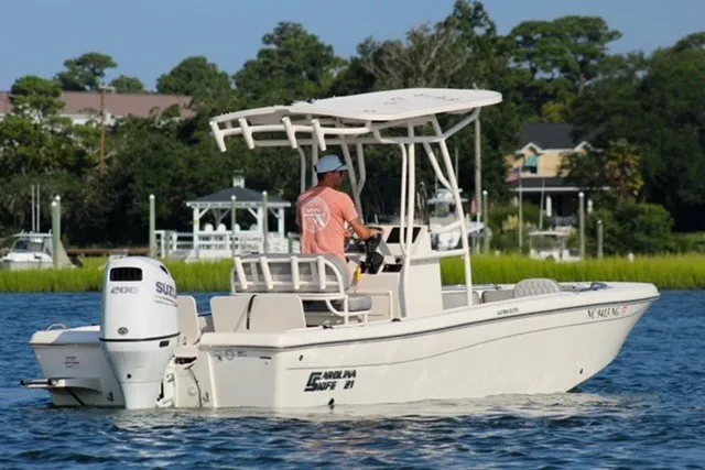 Slide: The Image of 2025 Carolina Skiff 21 Ultra Elite boat cruising on a scenic waterway. - 5