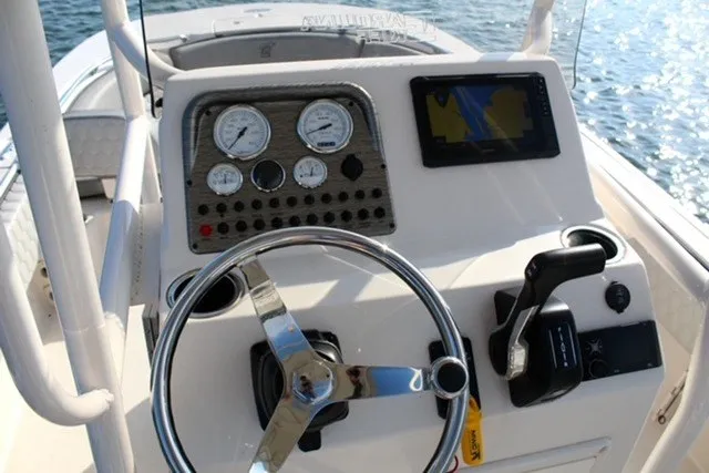 Slide: The Image of Center console of 2025 Carolina Skiff 21 Ultra Elite boat with steering wheel and navigation controls. - 6