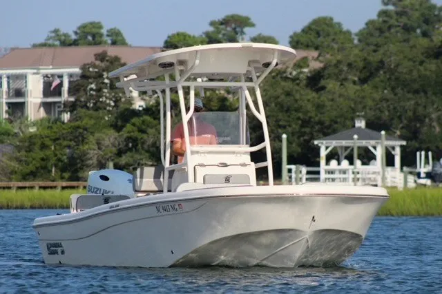 Slide: The Image of 2025 Carolina Skiff 21 Ultra Elite boat cruising on a scenic waterway. - 2