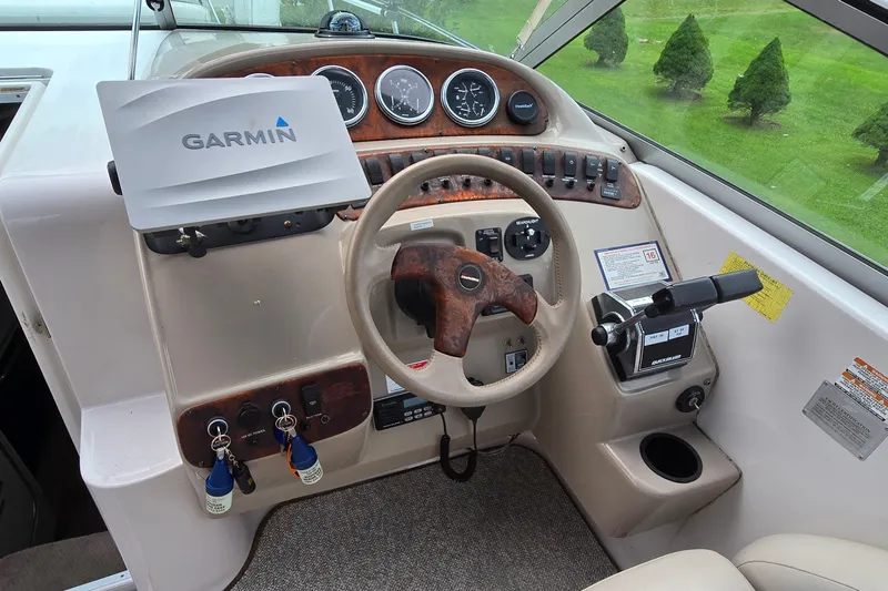 Slide: The Image of 1998 Chaparral Signature 300 boat dashboard with Garmin GPS and control panel. - 14