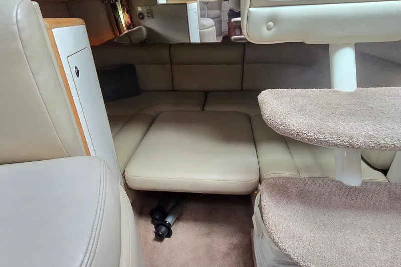 Slide: The Image of 1998 Chaparral Signature 300 interior with beige seating and carpeted stairs. - 21