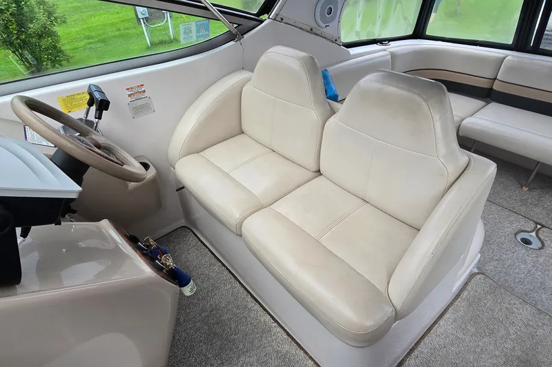 Slide: The Image of 1998 Chaparral Signature 300 boat interior with beige seating and steering wheel. - 15