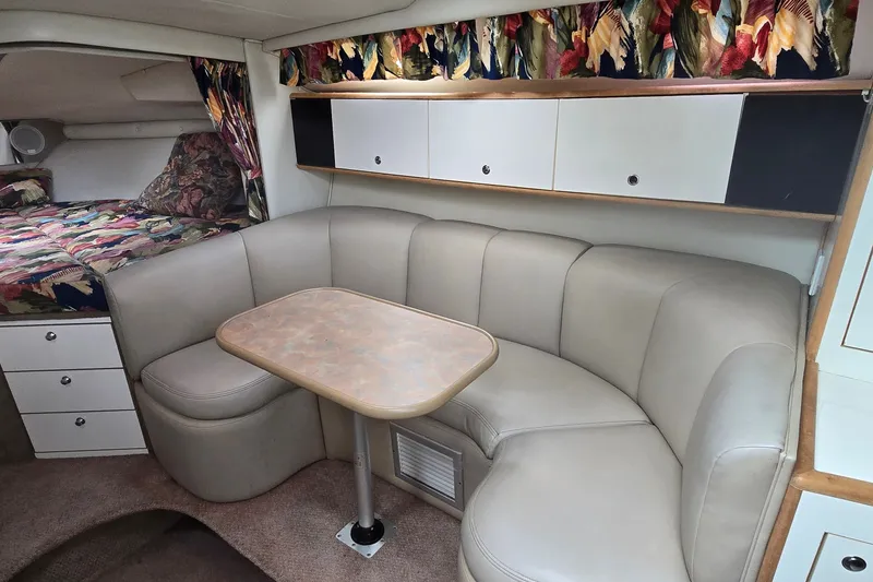 Slide: The Image of Interior of 1998 Chaparral Signature 300 boat with beige seating and floral decor. - 23