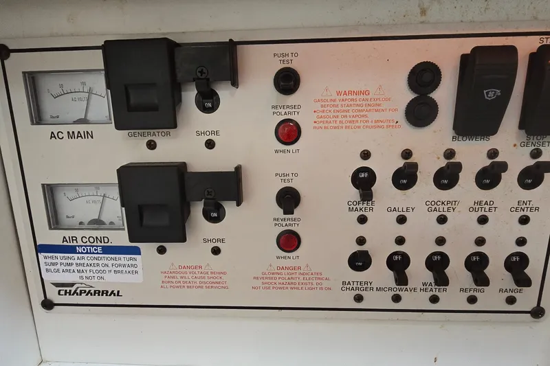 Slide: The Image of Control panel of a 1998 Chaparral Signature 300 boat with various switches and warnings. - 24