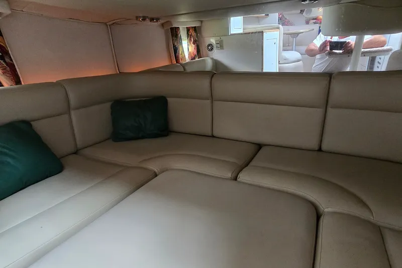 Slide: The Image of Interior of 1998 Chaparral Signature 300 boat with beige seating and green cushions. - 22