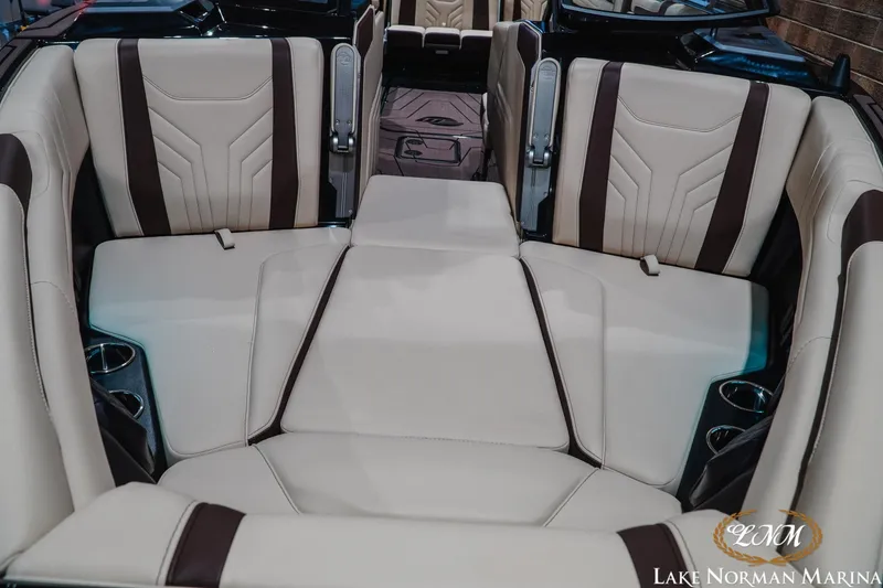 Slide: The Image of 2027 Malibu Wakesetter 25 LSV interior with beige and brown seating, cup holders visible. - 5