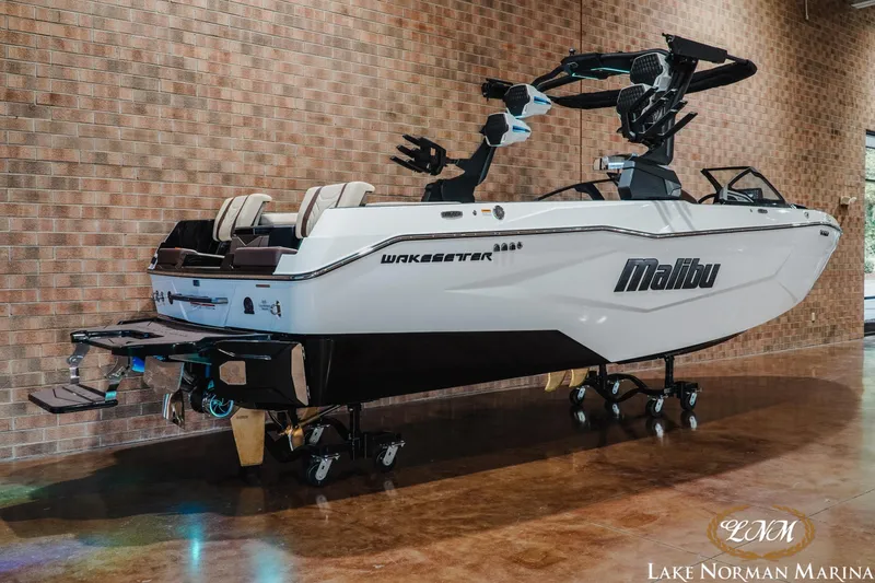 Slide: The Image of 2027 Malibu Wakesetter 25 LSV boat displayed indoors at Lake Norman Marina. - 2