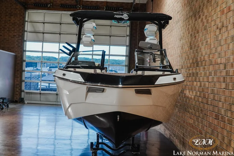 Slide: The Image of 2027 Malibu Wakesetter 25 LSV boat displayed indoors at Lake Norman Marina. - 4