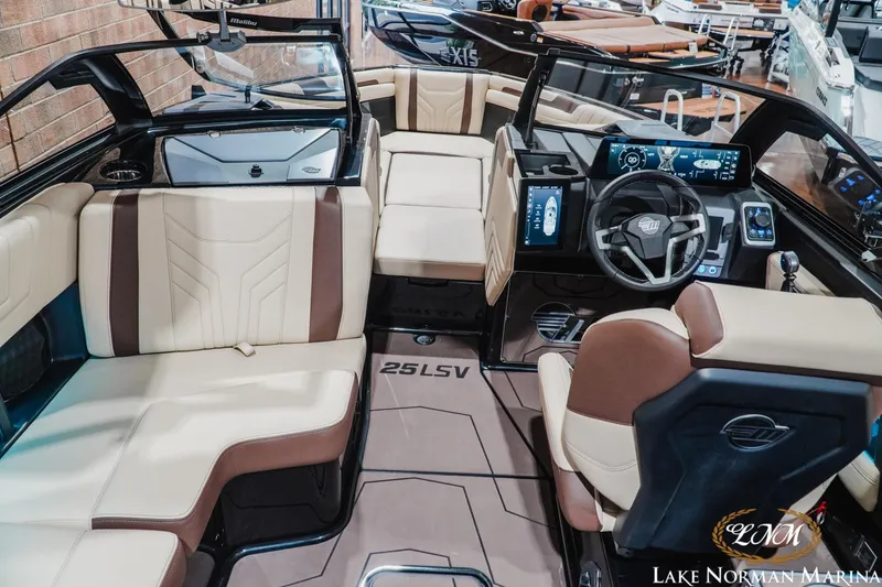 Slide: The Image of Interior of 2027 Malibu Wakesetter 25 LSV boat with luxurious seating and modern dashboard. - 19