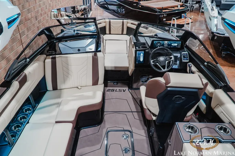 Slide: The Image of 2027 Malibu Wakesetter 25 LSV interior with luxurious seating and advanced dashboard. - 14