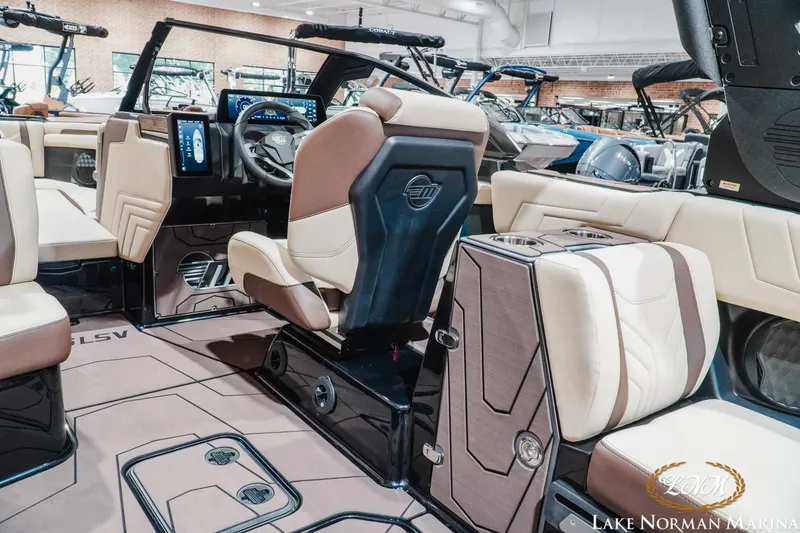 Slide: The Image of 2027 Malibu Wakesetter 25 LSV interior with luxurious seating and modern dashboard. - 18