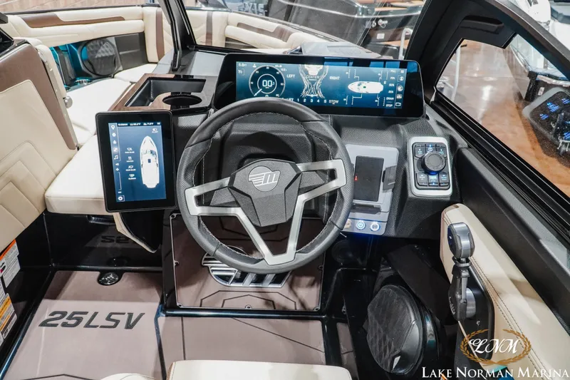 Slide: The Image of 2027 Malibu Wakesetter 25 LSV dashboard with advanced digital controls and steering wheel. - 21