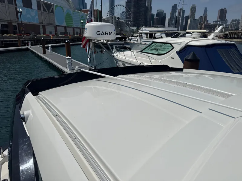 Slide: The Image of A 2020 Beneteau Gran Turismo 40 docked in a modern marina with a cityscape view. - 26