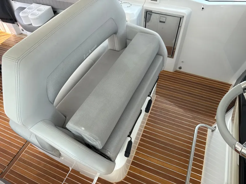 Slide: The Image of The 2020 Beneteau Gran Turismo 40 features a sleek gray cushioned bench on a wooden deck. - 15