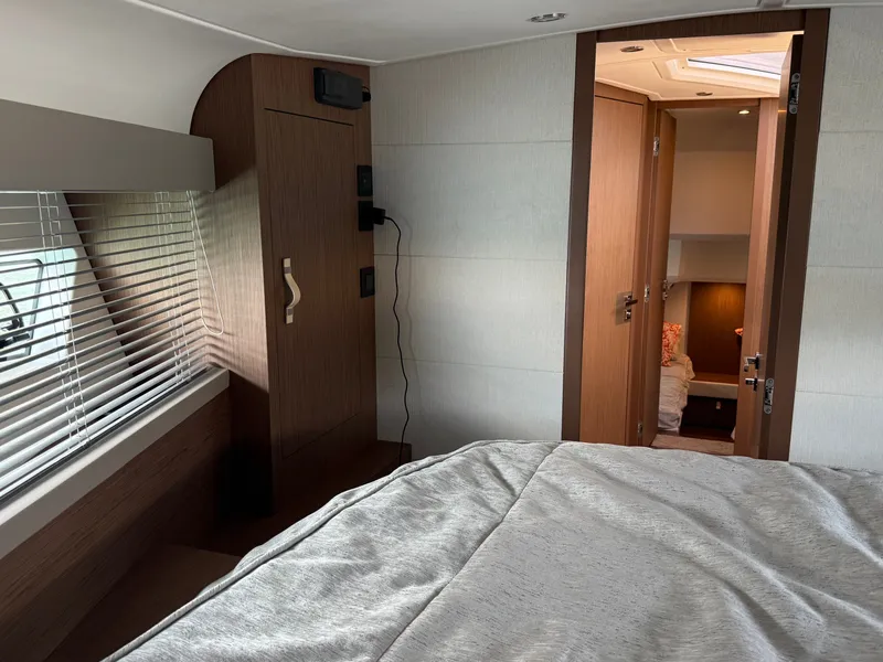 Slide: The Image of Interior of a 2020 Beneteau Gran Turismo 40 with a cozy bed and wooden furnishings. - 45