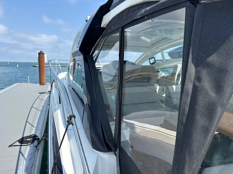 Slide: The Image of The 2020 Beneteau Gran Turismo 40 is docked. It features a sleek design with large windows. - 24