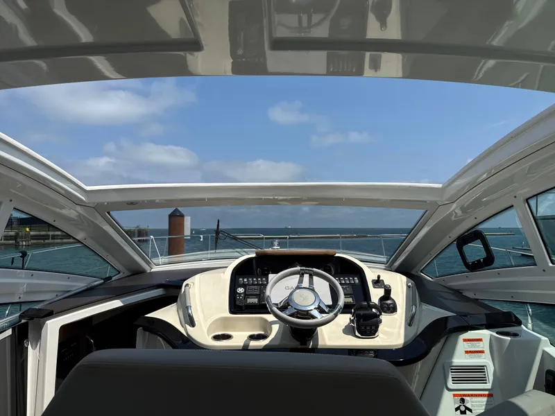 Slide: The Image of The cockpit of a 2020 Beneteau Gran Turismo 40 with modern steering and electronics. - 21