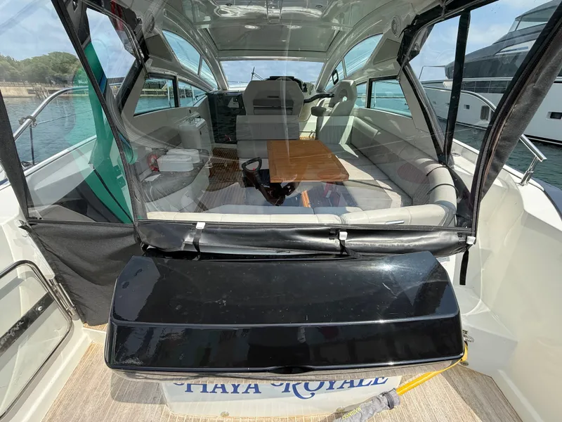 Slide: The Image of The image shows the cockpit of a 2020 Beneteau Gran Turismo 40 with a wooden table. - 5