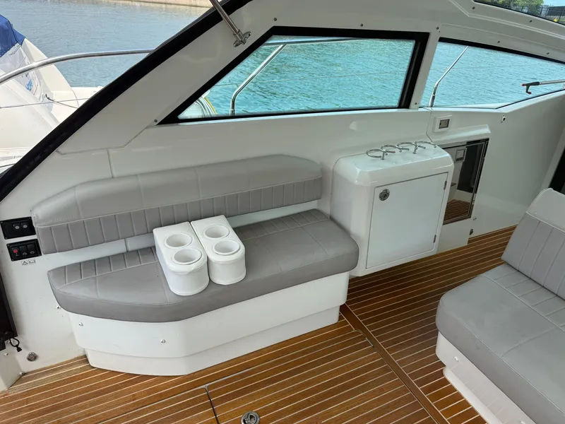 Slide: The Image of The image shows the cockpit of a 2020 Beneteau Gran Turismo 40 with gray seating and wood flooring. - 13