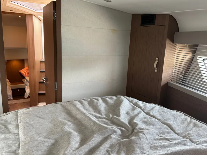 Slide: The Image of Interior of a 2020 Beneteau Gran Turismo 40 with a cozy bed and wooden furnishings. - 46