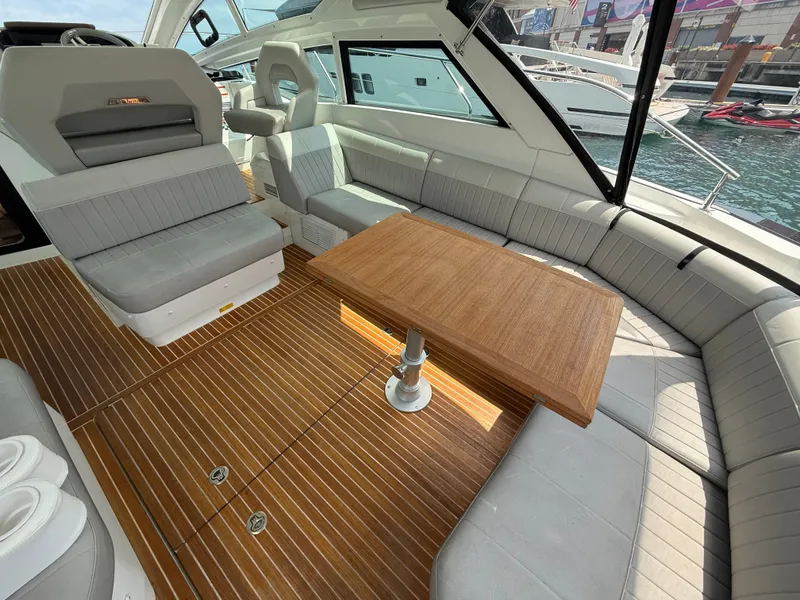 Slide: The Image of The image shows the interior of a 2020 Beneteau Gran Turismo 40 with sleek gray seating and a wooden table. - 10