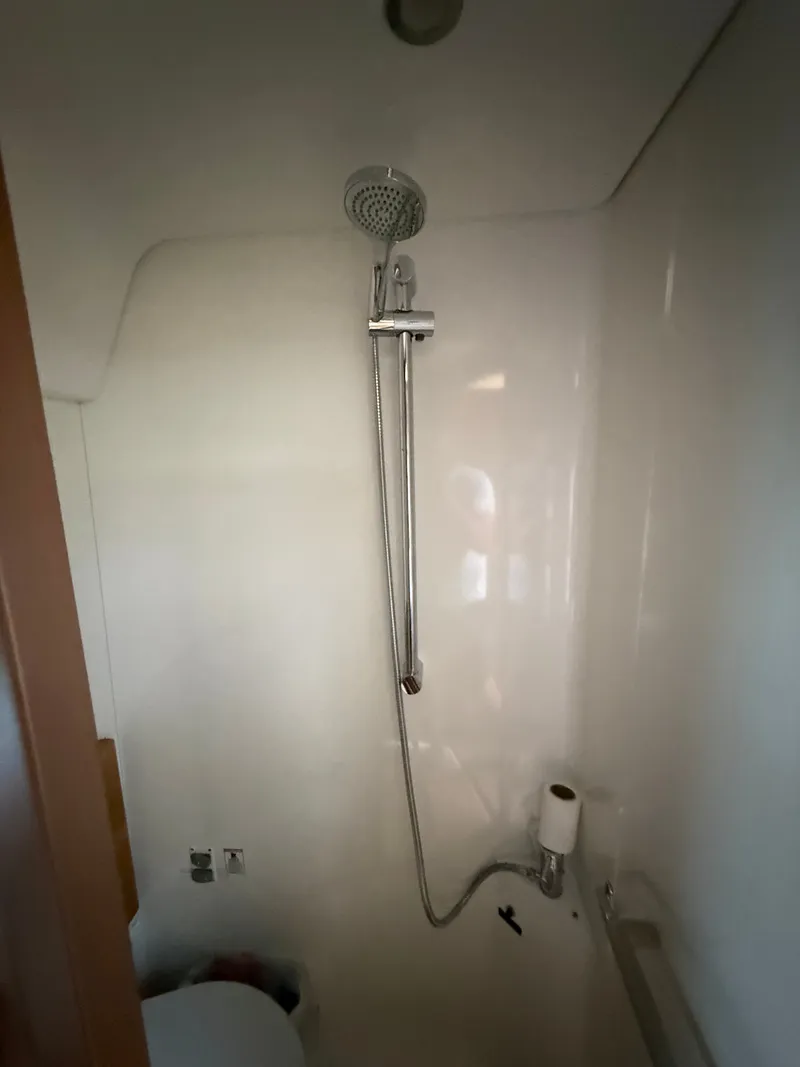 Slide: The Image of The shower in a modern boat cabin with a showerhead and handheld sprayer. - 49