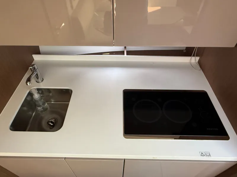 Slide: The Image of The 2020 Beneteau Gran Turismo 40 kitchen features a modern design with a sink and cooktop. - 39