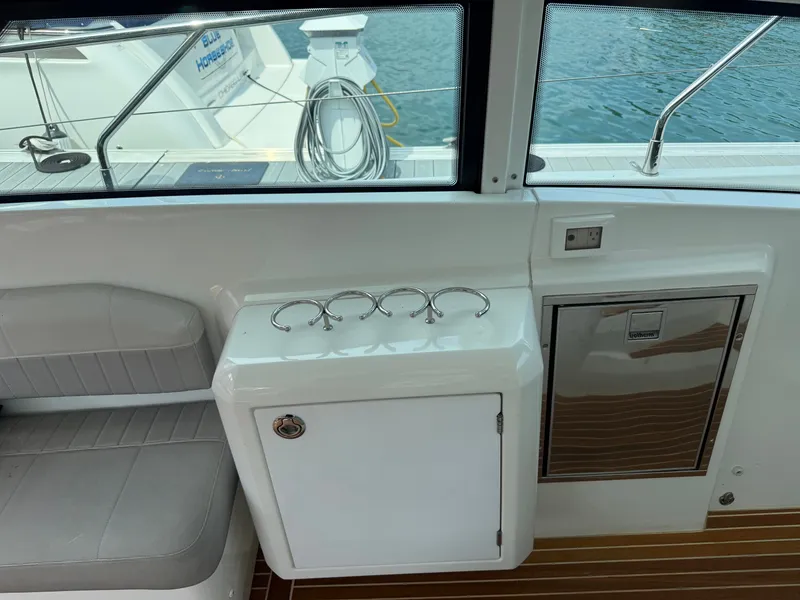 Slide: The Image of The 2020 Beneteau Gran Turismo 40 features an elegant seating area and a compact cooler. - 12