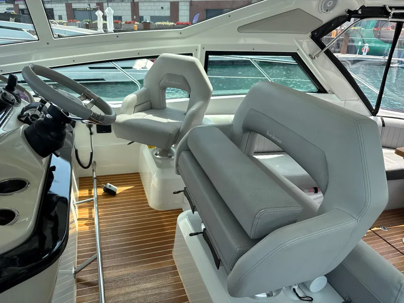 Slide: The Image of The cockpit of the 2020 Beneteau Gran Turismo 40 features modern seating and a sleek steering wheel. - 16