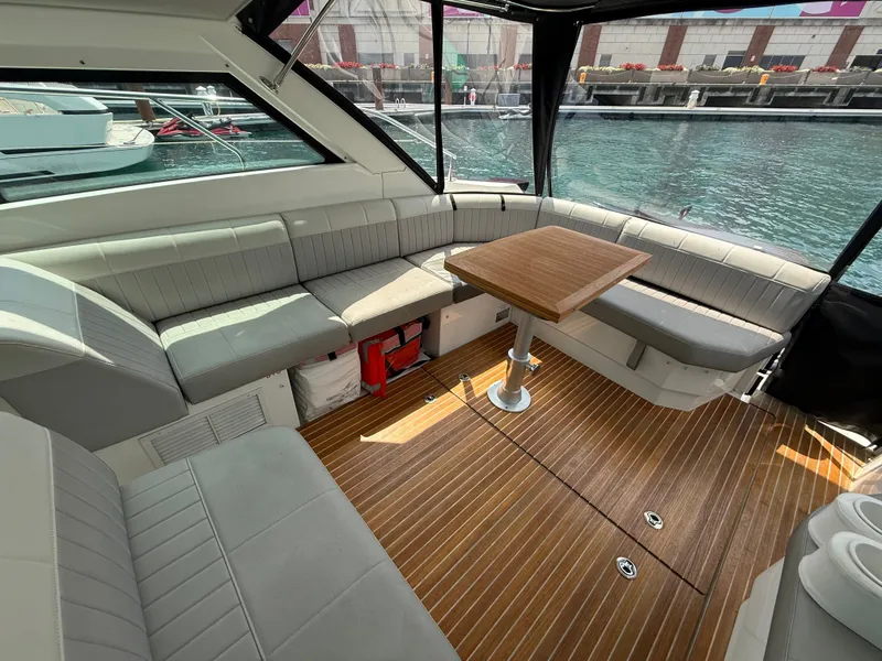 Slide: The Image of The image shows the cockpit of a 2020 Beneteau Gran Turismo 40 with gray seating and wood flooring. - 9