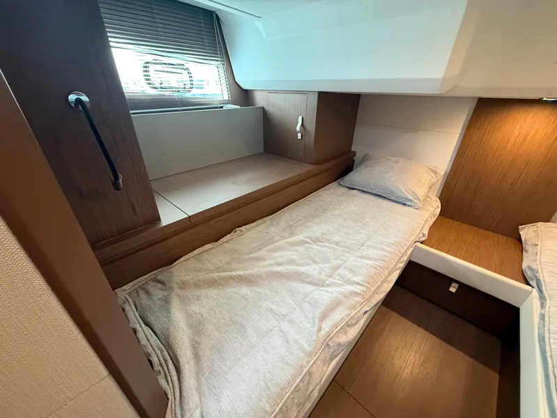 Slide: The Image of Interior of the 2020 Beneteau Gran Turismo 40 with twin beds and wood paneling. - 32