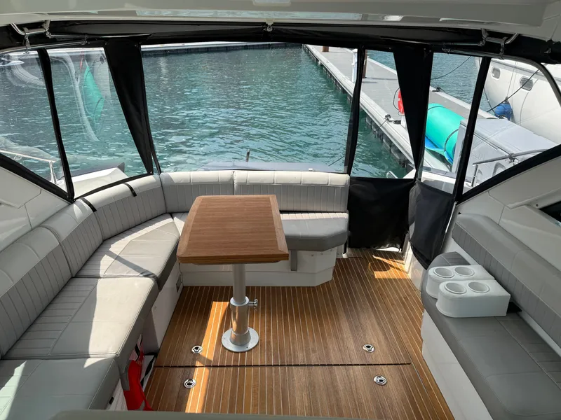 Slide: The Image of The image shows the cockpit of a 2020 Beneteau Gran Turismo 40 with gray seating and a wooden table. - 11