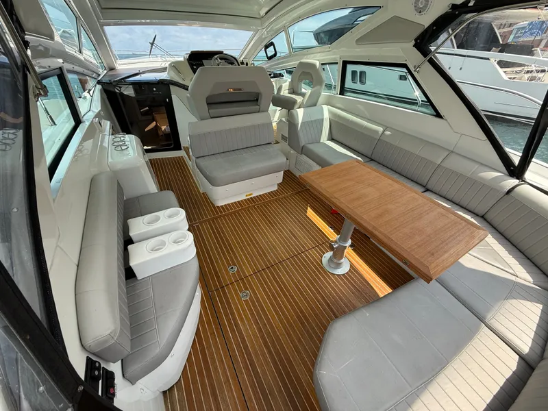 Slide: The Image of Interior of a 2020 Beneteau Gran Turismo 40 with sleek gray seating and wooden flooring. - 7