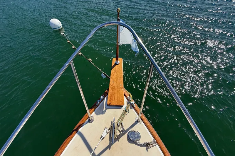 Slide: The Image of Bow view of 1978 Wasque 26 boat on sparkling water. - 19
