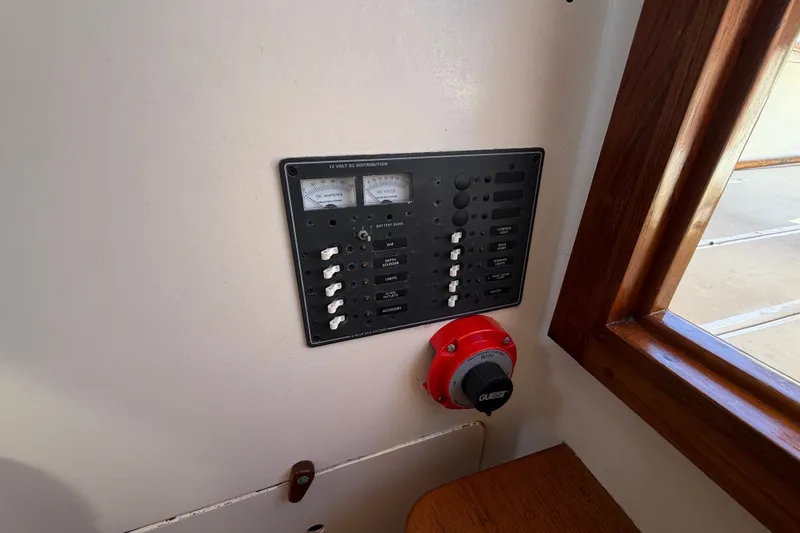 Slide: The Image of Electrical panel on a 1978 Wasque 26 boat, featuring switches and gauges. - 16