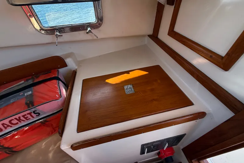 Slide: The Image of Interior of a 1978 Wasque 26 boat with wooden accents and life jackets. - 17