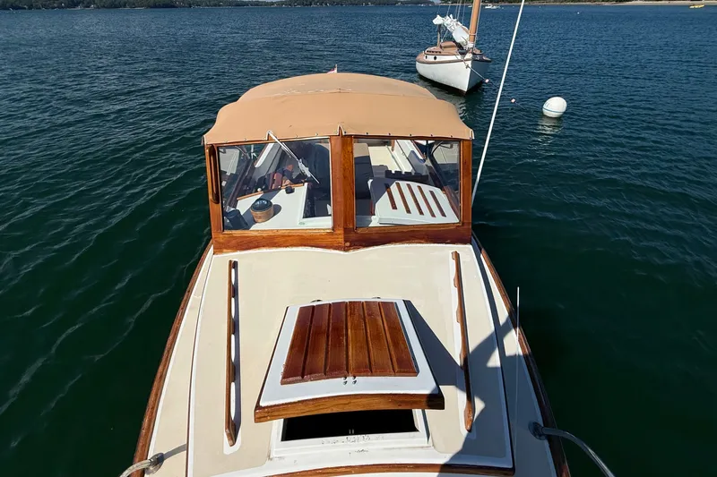 Slide: The Image of 1978 Wasque 26 boat with tan canopy on calm water. - 20